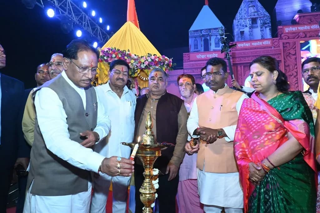 A lamp being lit on the Rajim mela stage, with Rajesh Agrawal in the dark vest