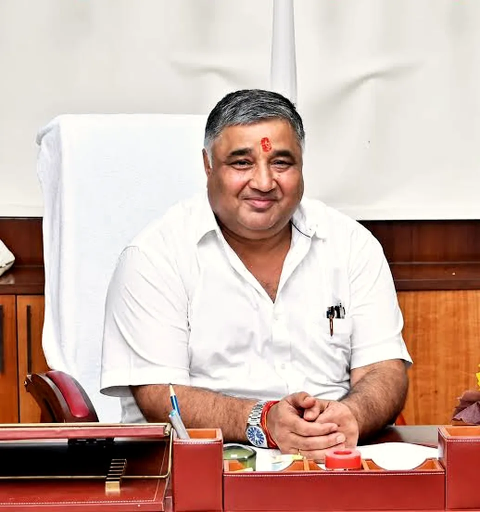 Rajesh Agrawal seated at his ministerial office desk in a white shirt