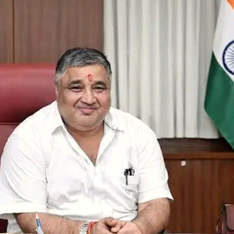 Rajesh Agrawal at his office with the Indian national flag behind him