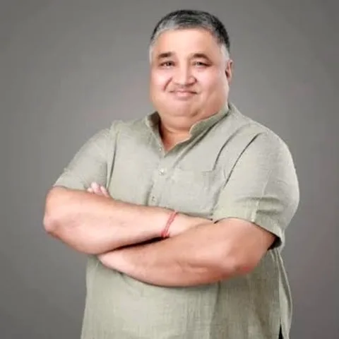 Studio portrait of Rajesh Agrawal with arms folded